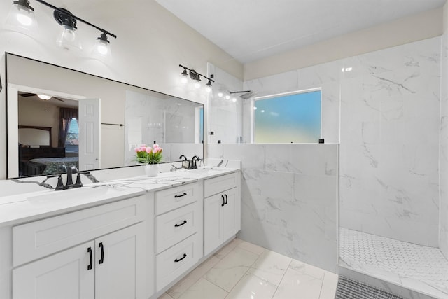 bathroom with plenty of natural light, vanity, and tiled shower