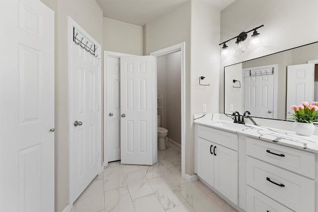 bathroom featuring vanity and toilet