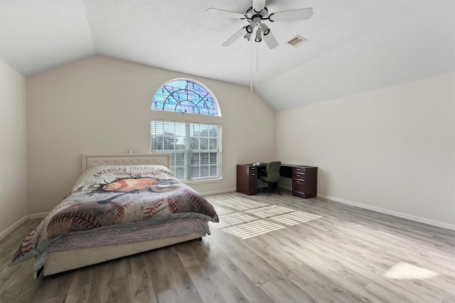 bedroom with ceiling fan, vaulted ceiling, and light wood-type flooring