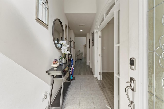 corridor featuring light tile patterned floors