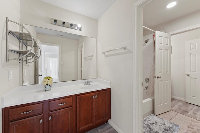 bathroom featuring vanity, tile patterned flooring, and shower / bathing tub combination