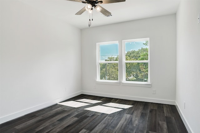 spare room featuring ceiling fan and dark wood-type flooring