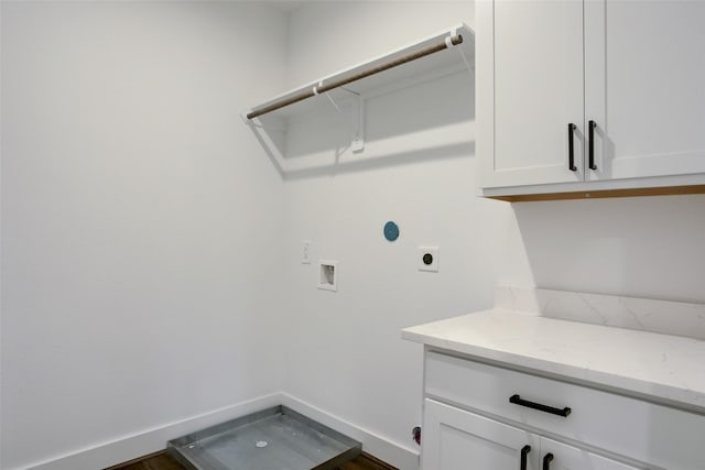 laundry area with hookup for an electric dryer, washer hookup, and cabinets