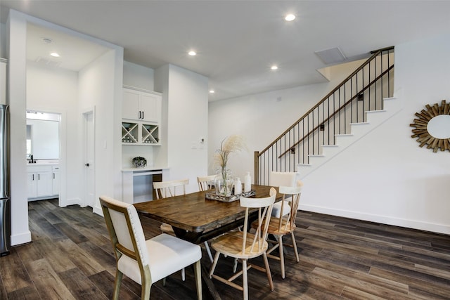 dining space with dark hardwood / wood-style flooring