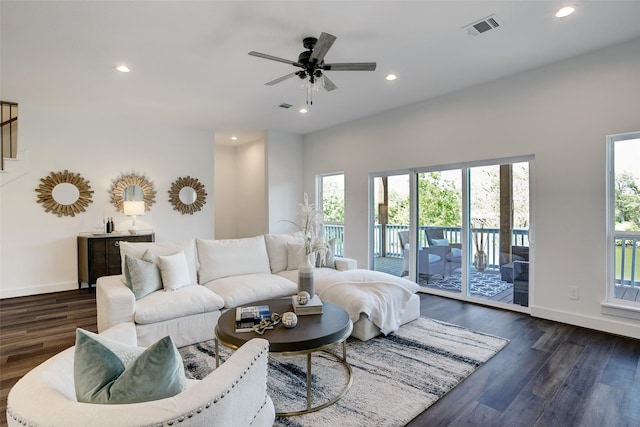 living room with ceiling fan and dark wood-type flooring