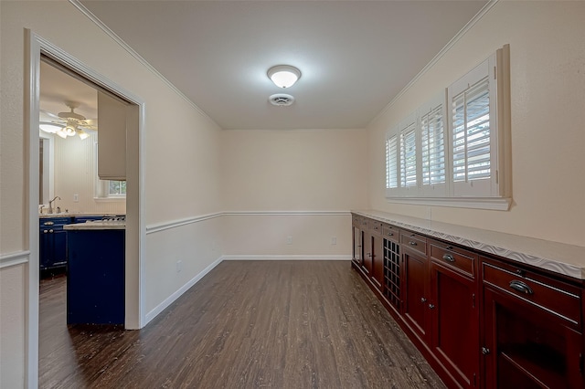 unfurnished room featuring ceiling fan, dark hardwood / wood-style flooring, and ornamental molding