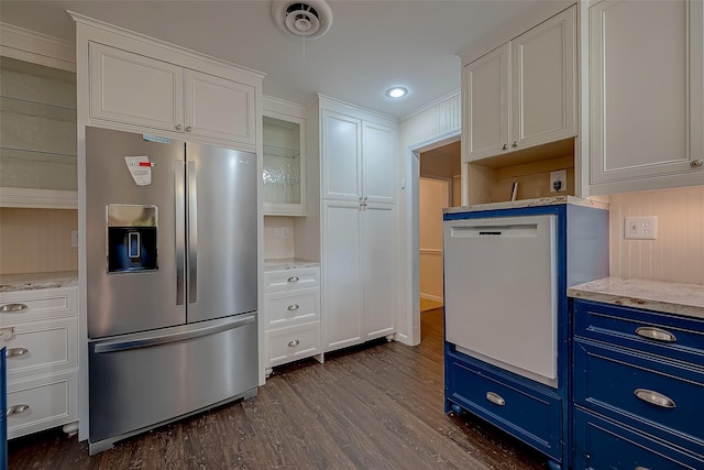 kitchen with stainless steel fridge, white dishwasher, blue cabinetry, dark hardwood / wood-style floors, and white cabinetry