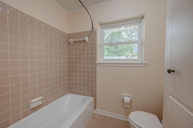 bathroom with tile patterned flooring, toilet, ornamental molding, and tiled shower / bath