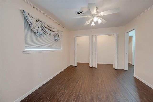 unfurnished bedroom featuring dark hardwood / wood-style floors, ceiling fan, and crown molding