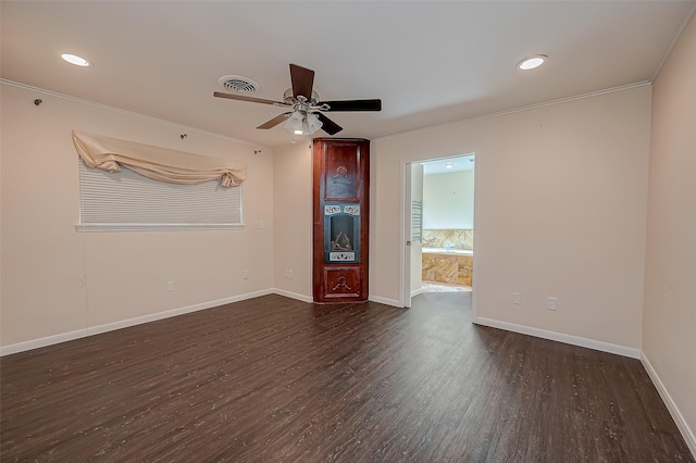 empty room with dark hardwood / wood-style floors, ceiling fan, and crown molding