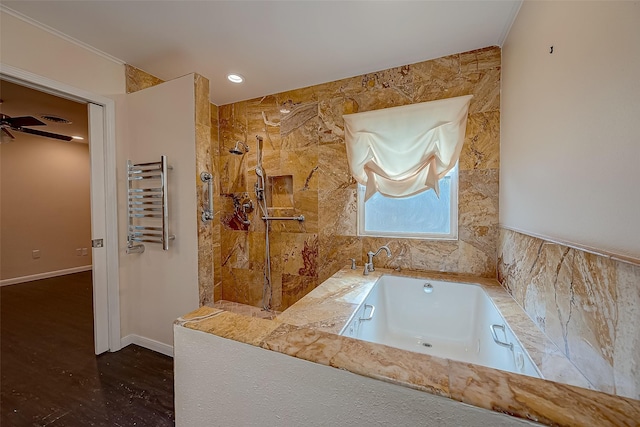 bathroom featuring ceiling fan, radiator heating unit, and plus walk in shower