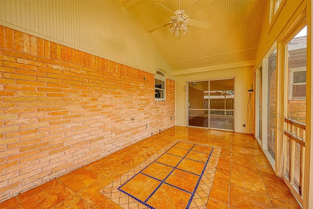 unfurnished sunroom featuring ceiling fan and vaulted ceiling