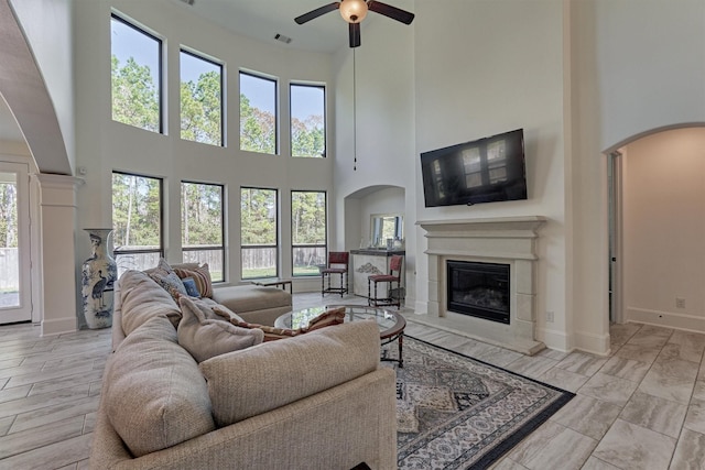 living room with a high ceiling and ceiling fan