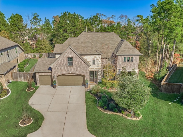 view of front of property featuring a front lawn and a garage