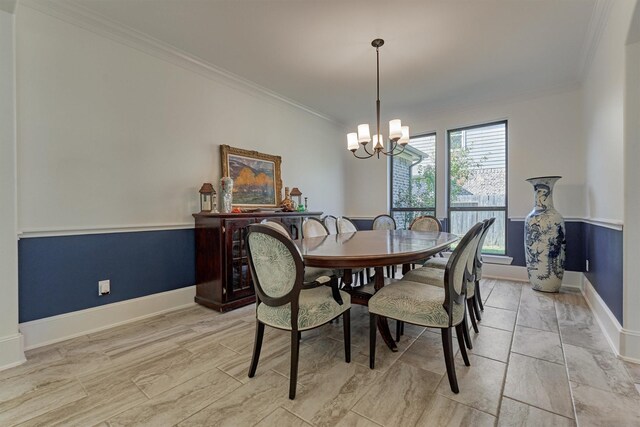 dining room with a notable chandelier and crown molding