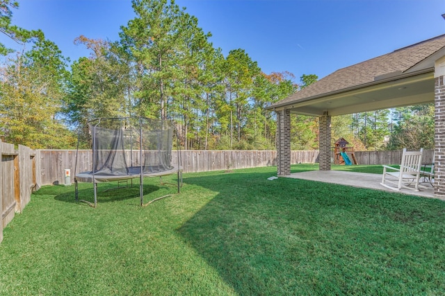 view of yard with a patio area, a playground, and a trampoline