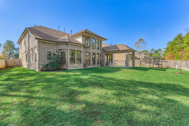 back of house with a lawn