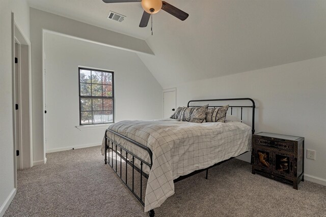 bedroom featuring vaulted ceiling, ceiling fan, and carpet