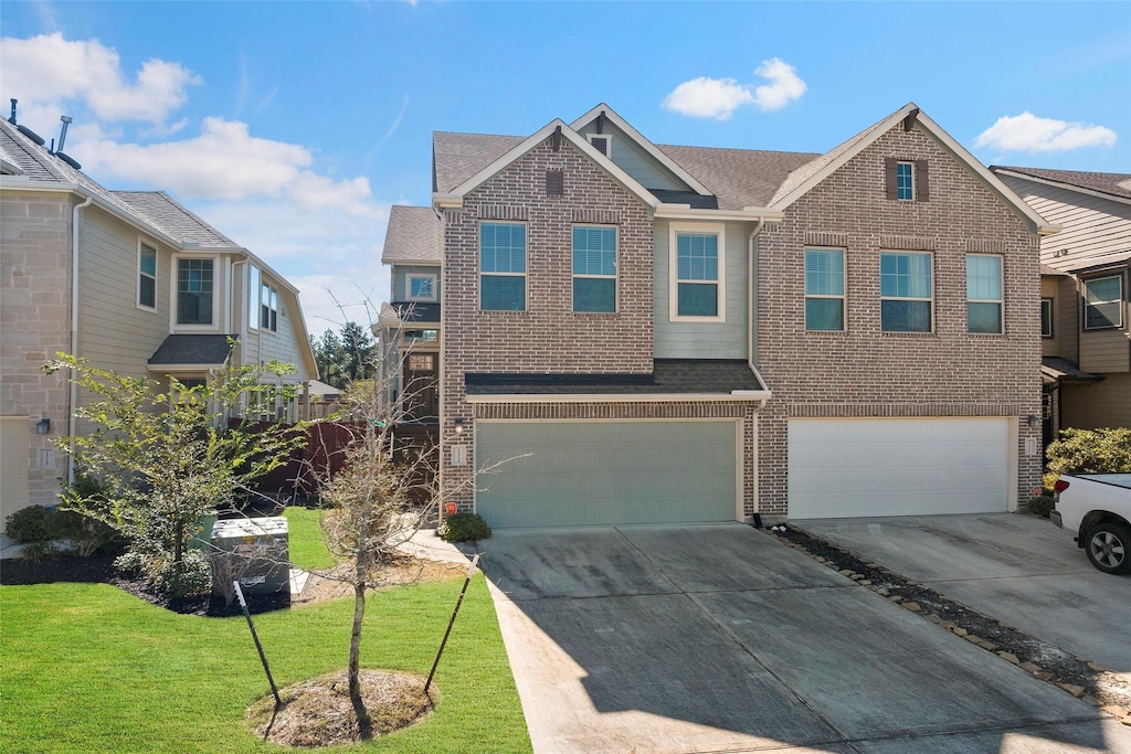 view of front of house featuring a garage and a front lawn