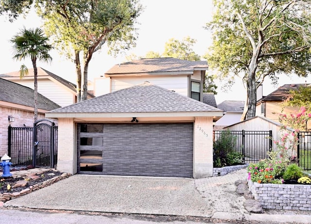 view of front of home with a garage and an outbuilding