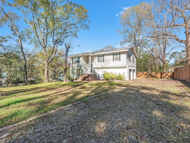 split foyer home with a front yard and a garage