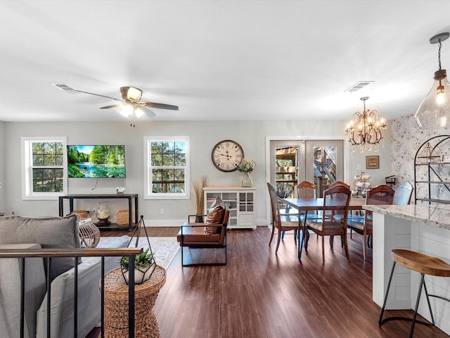 living room with french doors, dark wood-type flooring, and ceiling fan with notable chandelier