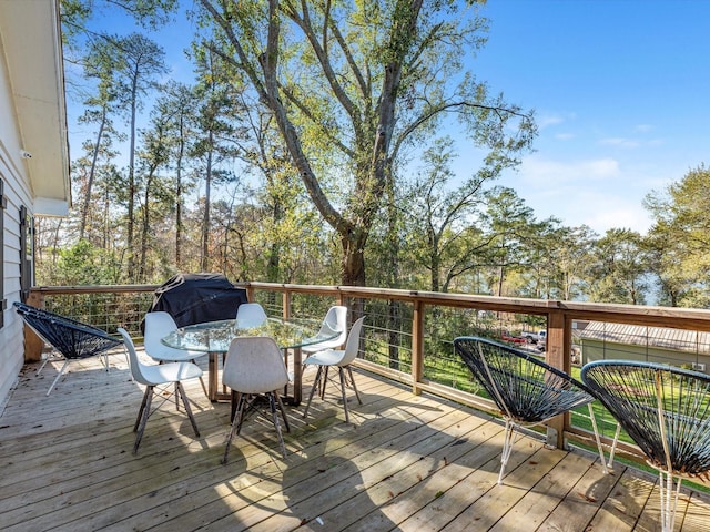 deck featuring outdoor dining area and area for grilling