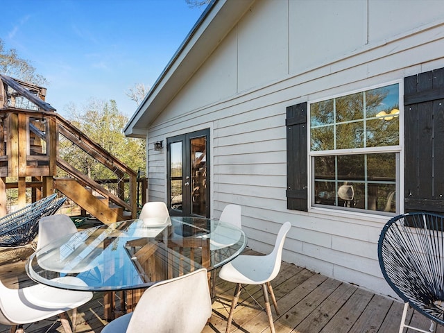 wooden deck with outdoor dining space and french doors