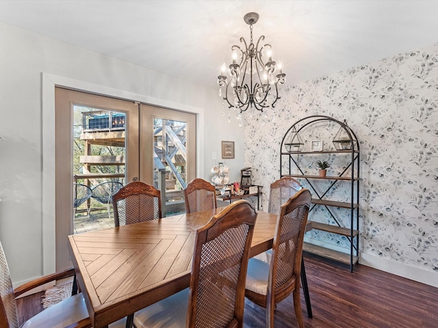 dining space featuring french doors, wood finished floors, a chandelier, baseboards, and wallpapered walls