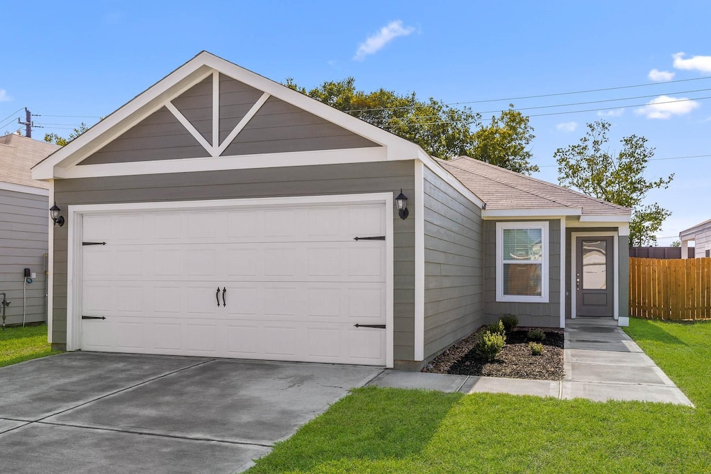 view of front facade with a front yard and a garage