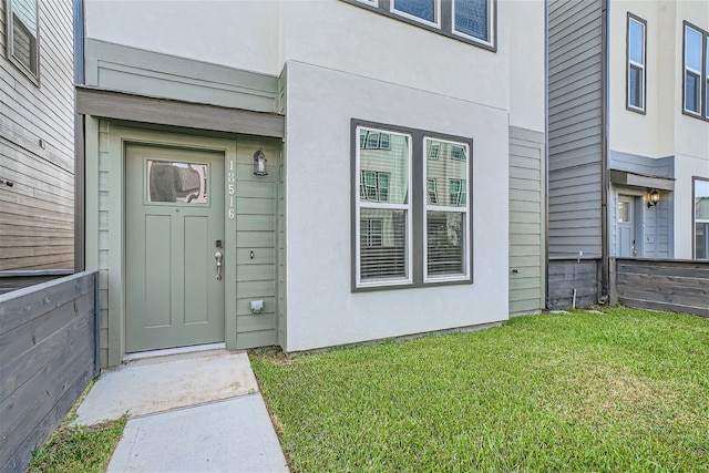 doorway to property featuring a yard