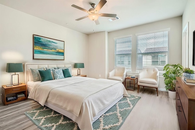 bedroom with light hardwood / wood-style floors and ceiling fan