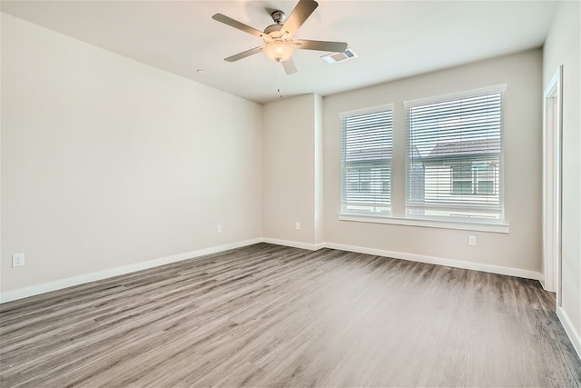 empty room with ceiling fan and hardwood / wood-style floors