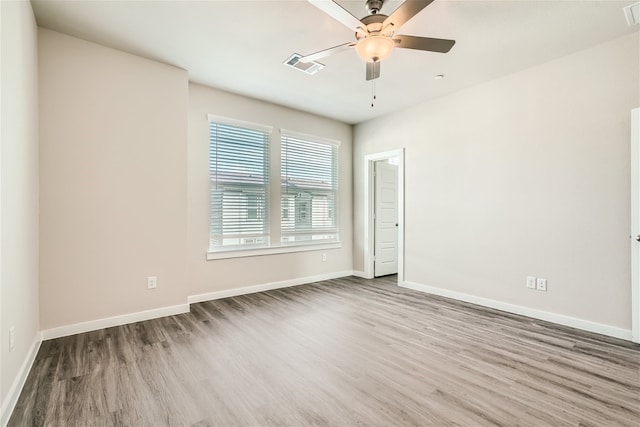 unfurnished room featuring ceiling fan and hardwood / wood-style floors