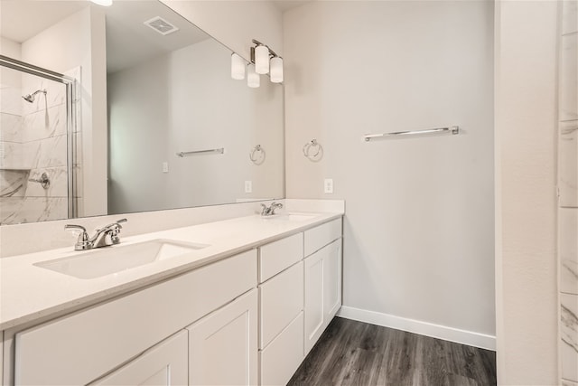 bathroom featuring vanity, a shower with shower door, and hardwood / wood-style flooring