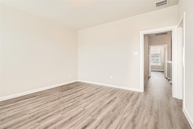 unfurnished room featuring light hardwood / wood-style floors