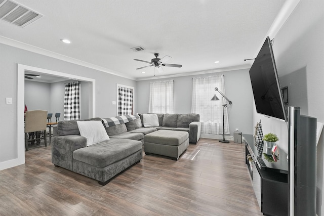 living room featuring ceiling fan, crown molding, and dark hardwood / wood-style floors