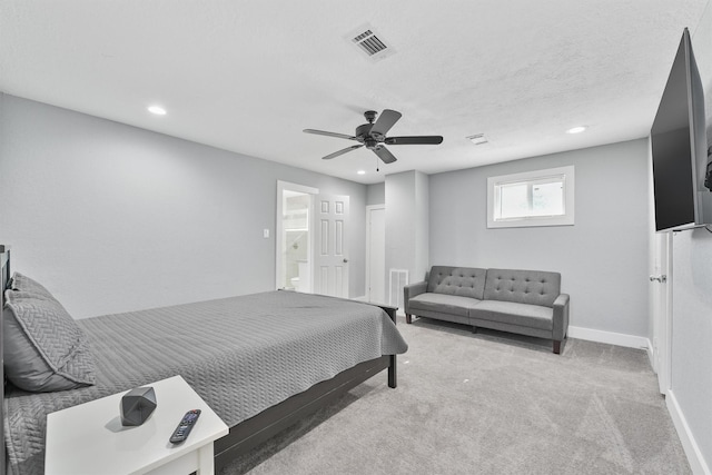 bedroom featuring light carpet, a textured ceiling, and ceiling fan