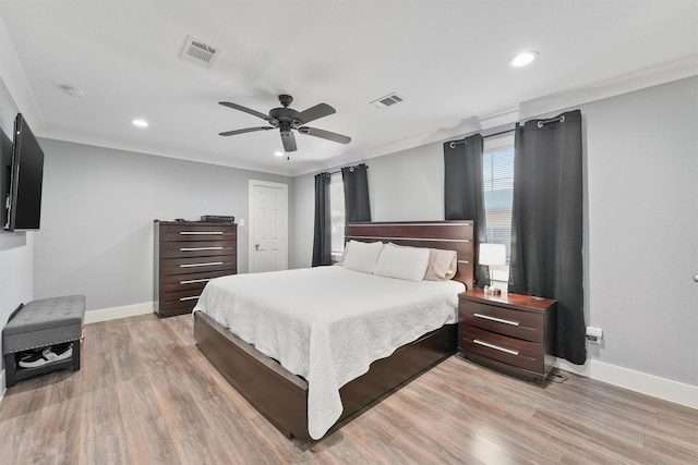 bedroom with wood-type flooring, ceiling fan, and ornamental molding