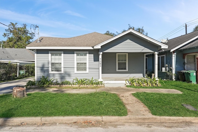 bungalow-style home featuring a front lawn and covered porch