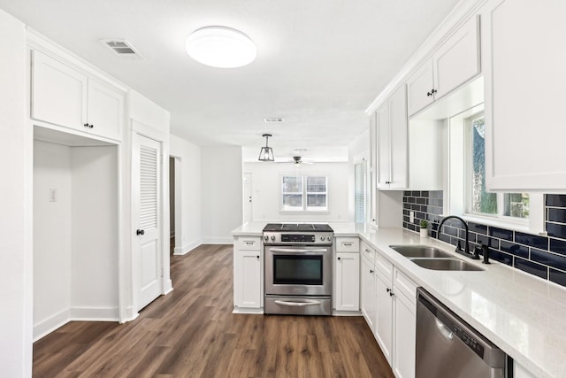 kitchen with sink, ceiling fan, dark hardwood / wood-style floors, white cabinetry, and stainless steel appliances