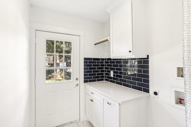 laundry room with washer hookup, plenty of natural light, electric dryer hookup, and cabinets