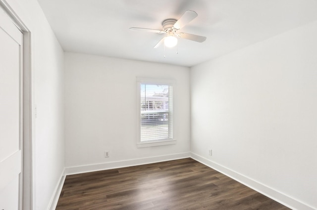 spare room featuring ceiling fan and dark hardwood / wood-style floors