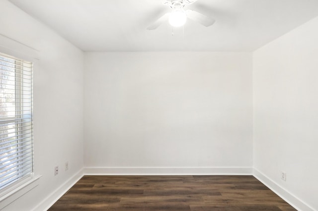 empty room with ceiling fan and dark wood-type flooring