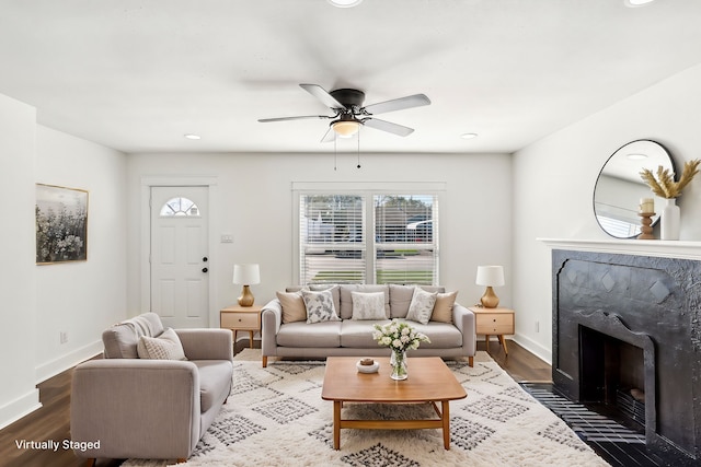 living room with ceiling fan and dark hardwood / wood-style flooring