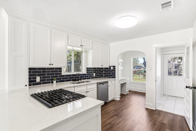 kitchen featuring stainless steel dishwasher, gas stovetop, white cabinets, and sink