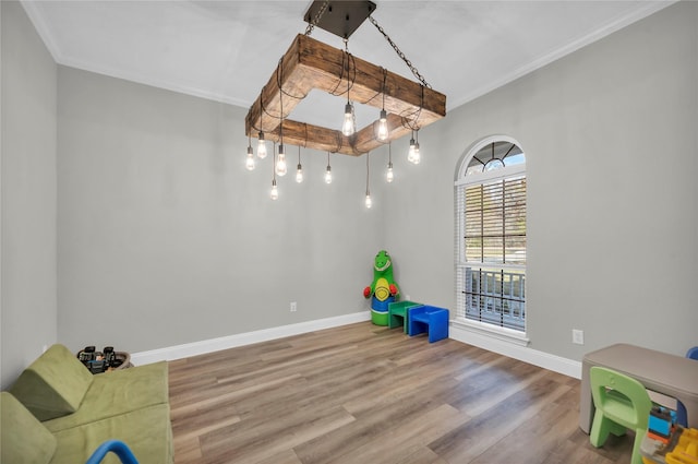 game room with crown molding and hardwood / wood-style flooring