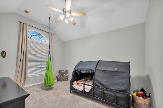 bedroom with ceiling fan, lofted ceiling, and carpet floors