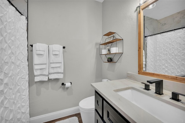 bathroom featuring hardwood / wood-style flooring, vanity, curtained shower, and toilet