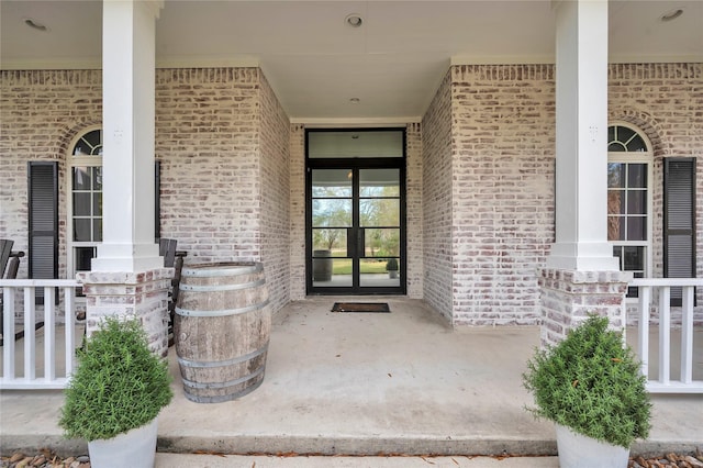 doorway to property featuring french doors and covered porch